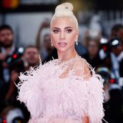 Andrea Raffin/Shutterstock Lady Gaga at a movie premiere, wearing a white feathery dress